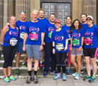 A NETA team in blue running vests and race numbers before the Great North Run